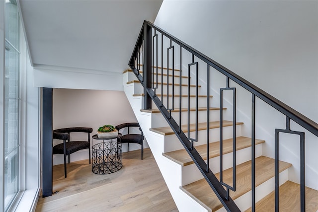 staircase with hardwood / wood-style floors