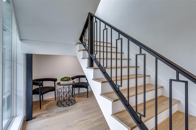 stairs featuring wood finished floors