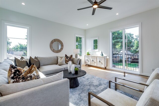 living room featuring ceiling fan and hardwood / wood-style flooring