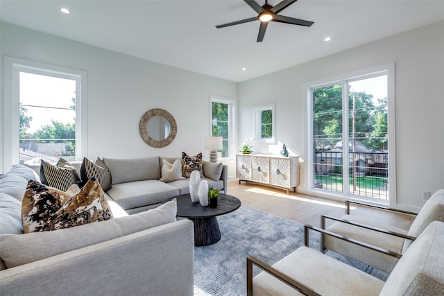 living room featuring recessed lighting, a healthy amount of sunlight, wood finished floors, and a ceiling fan