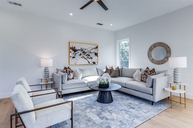 living room featuring light wood-type flooring and ceiling fan