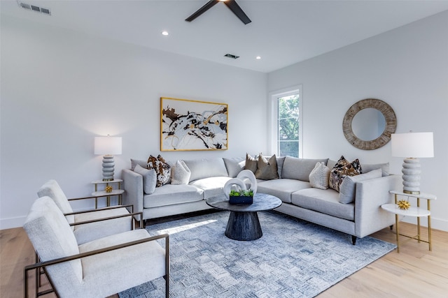 living room with a ceiling fan, recessed lighting, wood finished floors, and visible vents