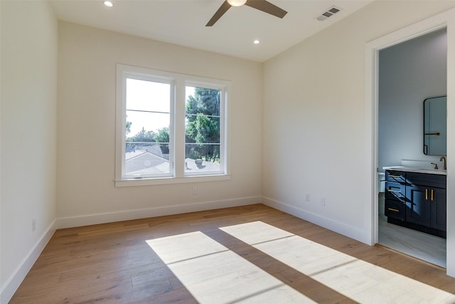 spare room featuring light wood-style flooring, recessed lighting, baseboards, and visible vents