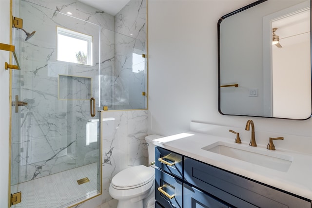 bathroom with a shower with shower door, toilet, and vanity