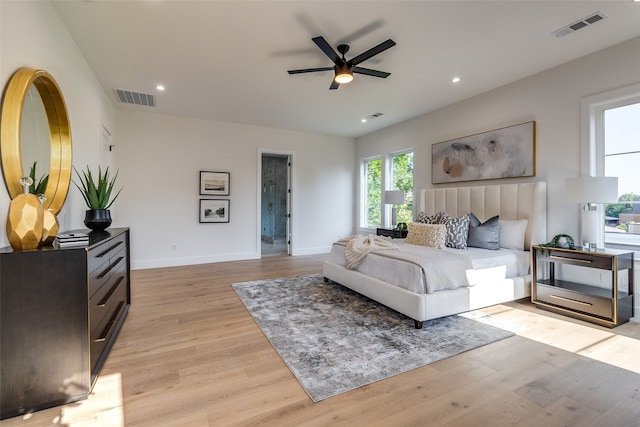 bedroom with ceiling fan and light hardwood / wood-style floors