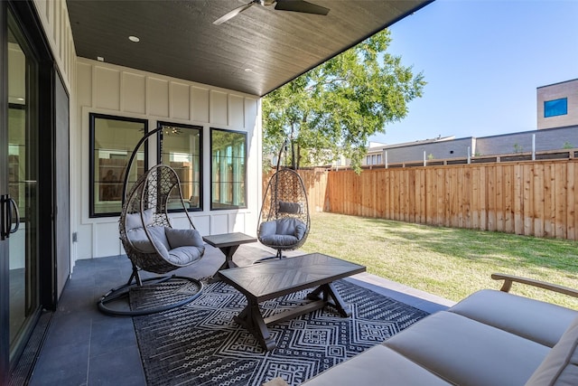 view of patio / terrace with an outdoor living space, ceiling fan, and fence