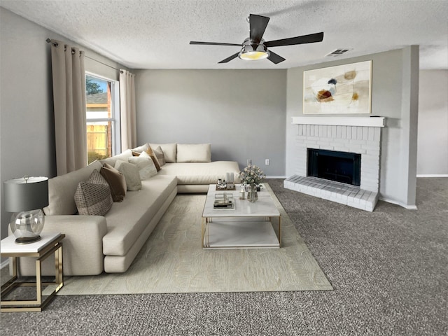 carpeted living room with a textured ceiling, a ceiling fan, visible vents, baseboards, and a brick fireplace