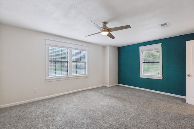 3018 Scorpio Dr, Granbury, TX 76049 - carpeted spare room featuring a ceiling fan, healthy amount of natural light, baseboards, and a textured ceiling
