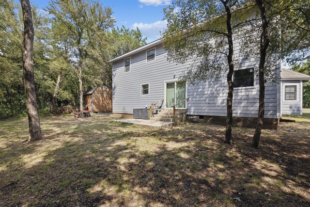 3018 Scorpio Dr, Granbury, TX 76049 - back of house featuring entry steps, a patio area, and central AC
