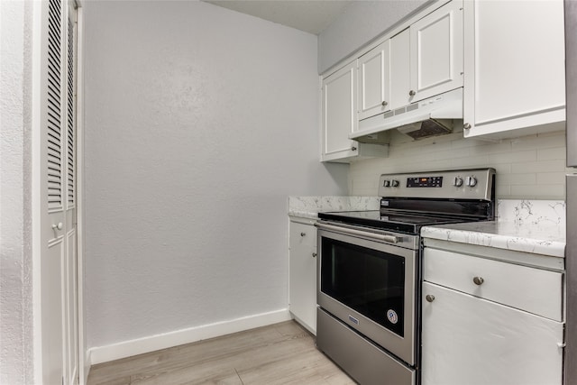 kitchen featuring light wood-type flooring, tasteful backsplash, stainless steel electric stove, and white cabinetry