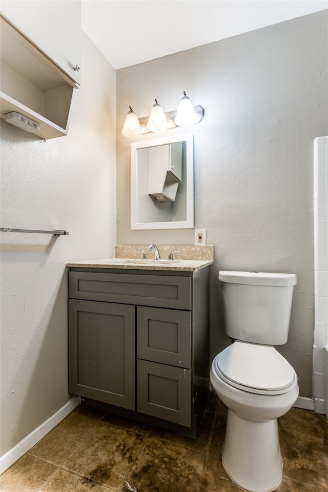 bathroom featuring toilet and vanity