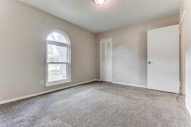 spare room featuring light carpet and a healthy amount of sunlight