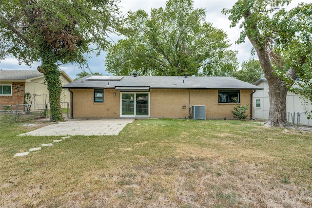 back of house with a yard, a patio area, and central AC