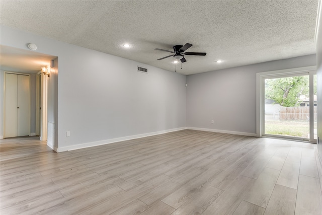 unfurnished room featuring a textured ceiling, ceiling fan, and light hardwood / wood-style floors