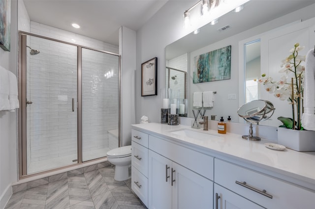 bathroom with tile patterned floors, an enclosed shower, vanity, and toilet