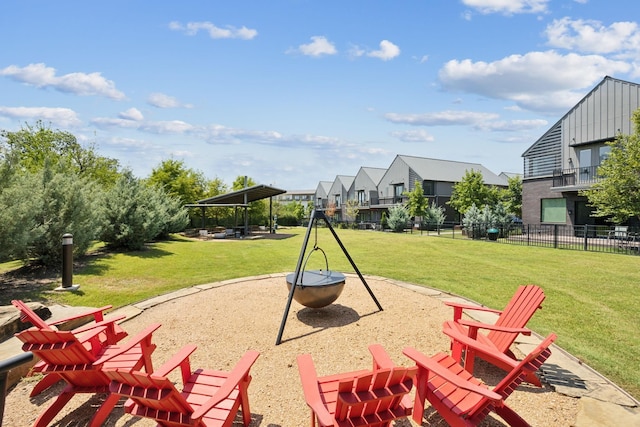 exterior space featuring a patio, a lawn, and an outdoor fire pit