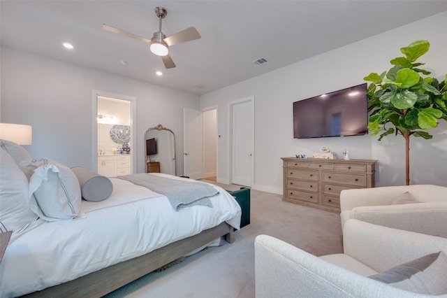 carpeted bedroom with connected bathroom and ceiling fan