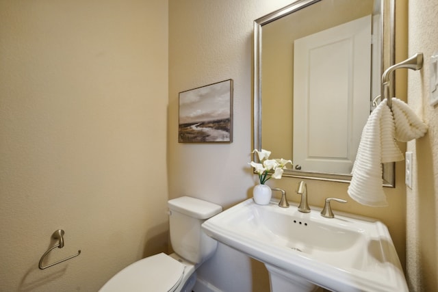 bathroom with toilet and sink