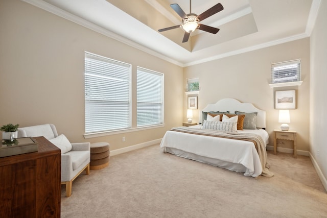 bedroom with ceiling fan, a raised ceiling, light carpet, and ornamental molding