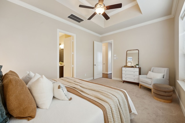 carpeted bedroom with crown molding, ceiling fan, a raised ceiling, and ensuite bath