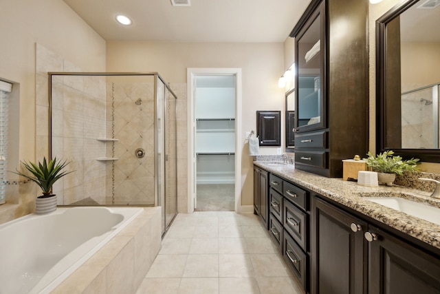 bathroom featuring tile patterned floors, shower with separate bathtub, and vanity