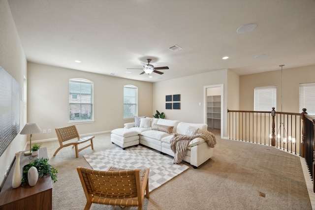 living room featuring ceiling fan and light carpet