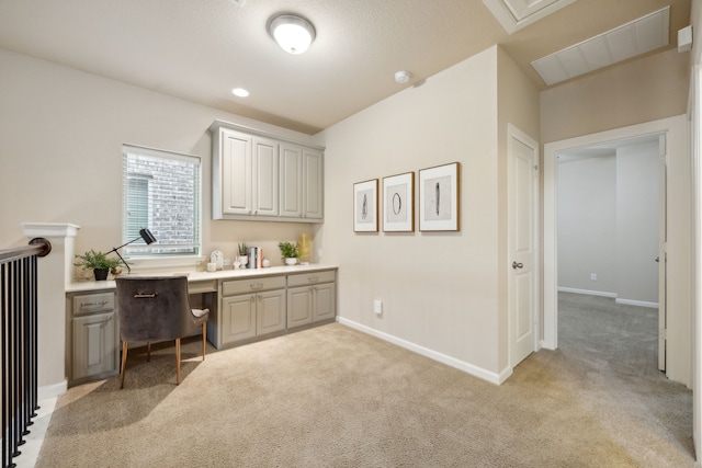 office area featuring built in desk and light carpet