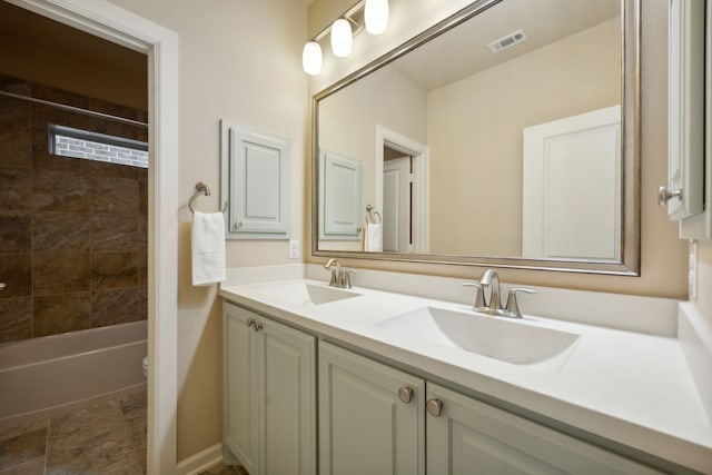 full bathroom featuring tiled shower / bath, toilet, and vanity