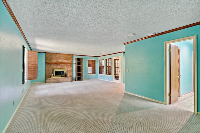 unfurnished living room with a textured ceiling, ornamental molding, light carpet, and a brick fireplace