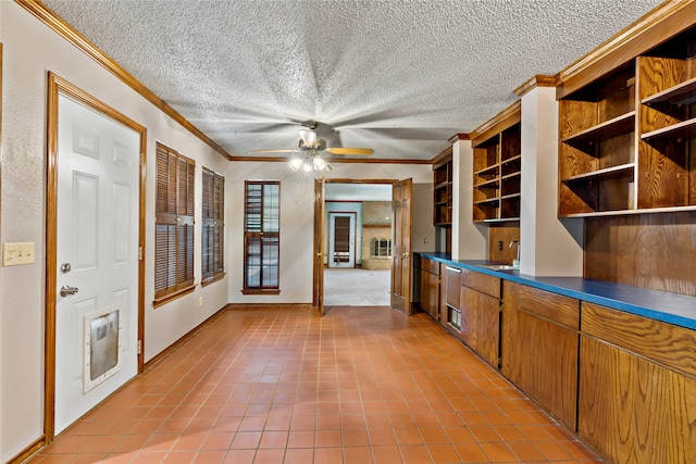 unfurnished office featuring a textured ceiling, ceiling fan, sink, and tile patterned flooring