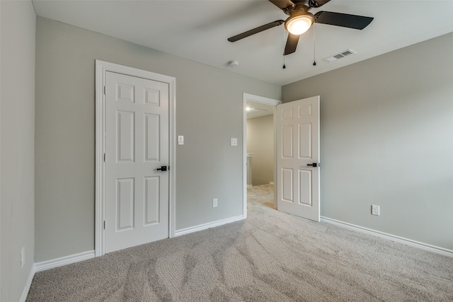 interior space with ceiling fan and light carpet