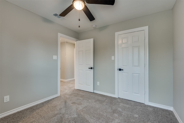 unfurnished bedroom featuring light colored carpet and ceiling fan