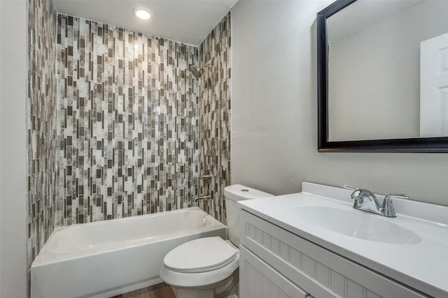 full bathroom with vanity, toilet, and tiled shower / bath