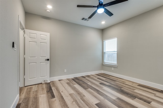 spare room with light hardwood / wood-style flooring and ceiling fan