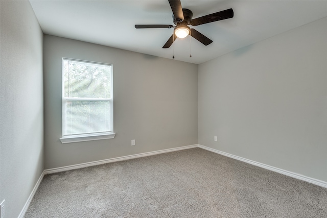 spare room featuring ceiling fan and carpet floors