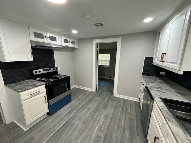 kitchen featuring black range with electric cooktop, wood-type flooring, white cabinetry, and tasteful backsplash