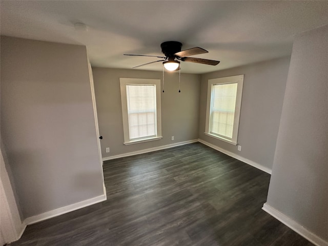 spare room with ceiling fan and dark hardwood / wood-style flooring