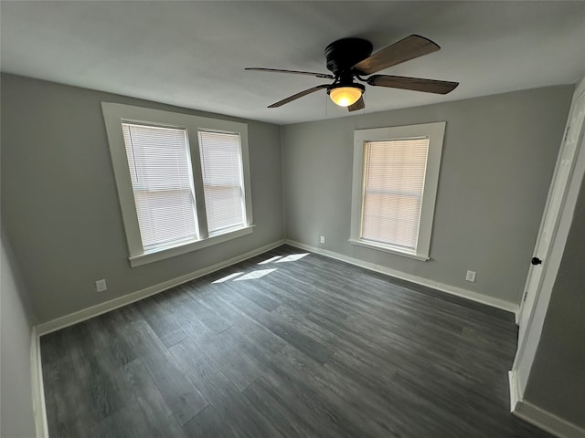 unfurnished room featuring dark wood-type flooring and ceiling fan