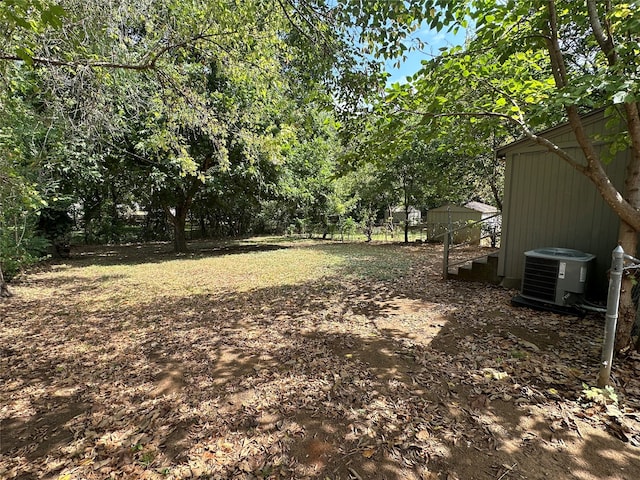 view of yard with central air condition unit