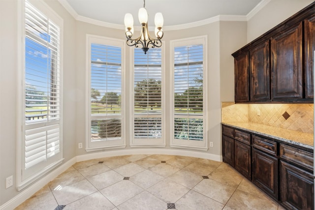 tiled dining area featuring crown molding, a wealth of natural light, and an inviting chandelier