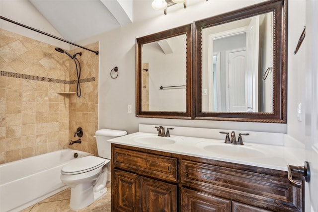 full bathroom featuring vanity, tile patterned floors, tiled shower / bath, vaulted ceiling, and toilet