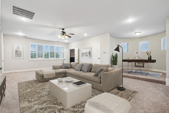 carpeted living room featuring ceiling fan