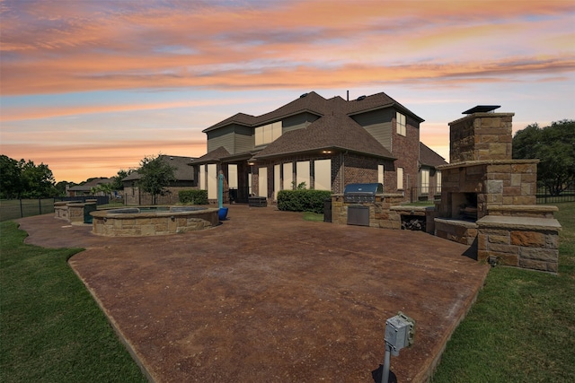 view of front of home featuring an outdoor stone fireplace and an outdoor kitchen