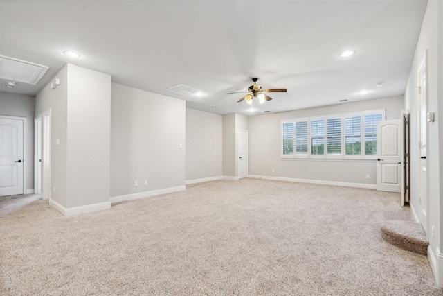 empty room with ceiling fan and light carpet