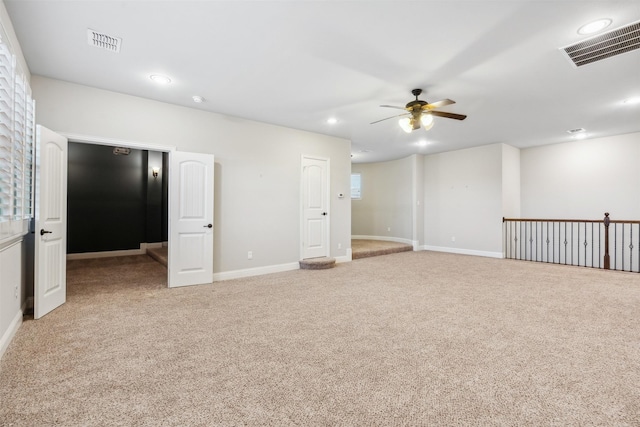 unfurnished room featuring ceiling fan and light carpet