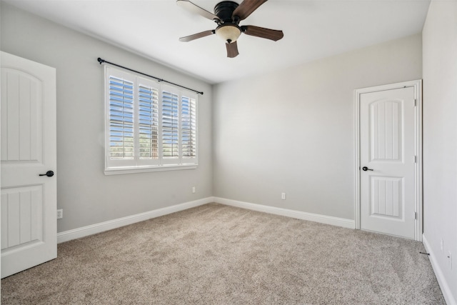 unfurnished room with ceiling fan and light carpet