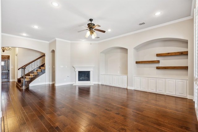 unfurnished living room with dark hardwood / wood-style flooring, ceiling fan, and crown molding