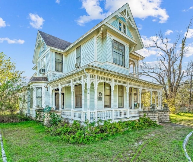 view of side of home with a lawn and a porch