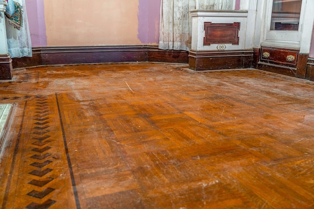 unfurnished living room featuring parquet flooring