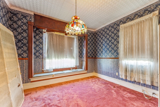 unfurnished dining area featuring carpet flooring and ornamental molding